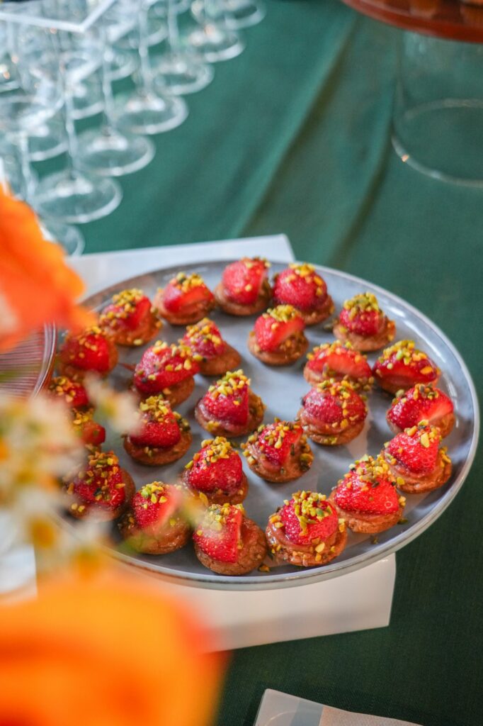 Plateau de tartelettes aux fraises sur une nappe verte