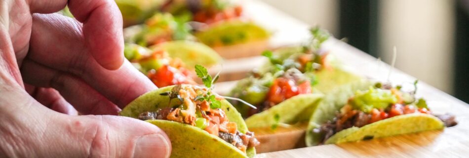 Invité saisissant un mini-taco sur une planche