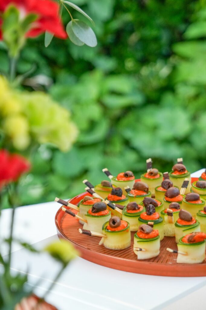 Roulés de concombre et anchois sur un plateau fleuri